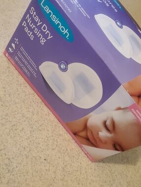 Lansinoh Stay Dry Nursing Pads in Purple and White Packaging